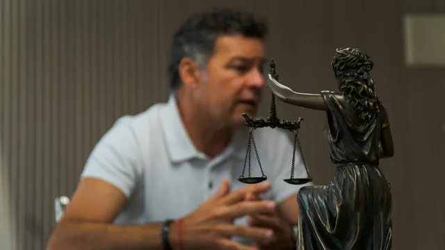 Lawyer signing documents at an office desk