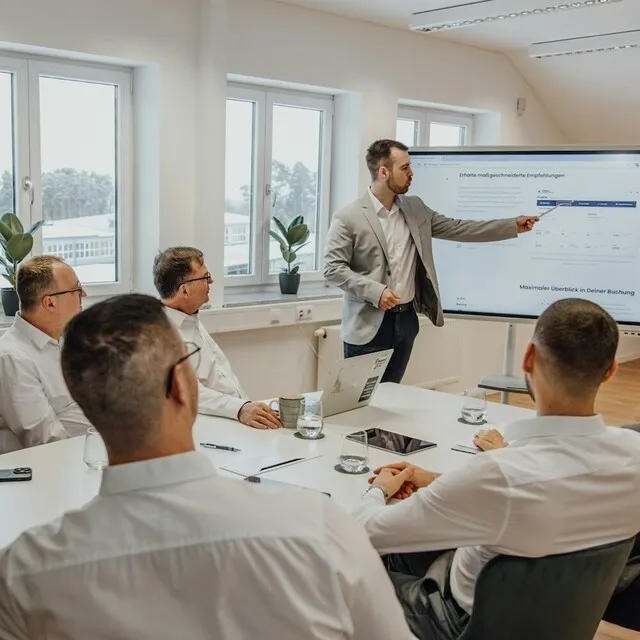 Group of people in a corporate presentation with charts