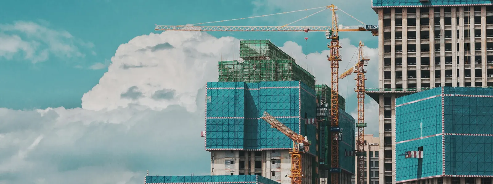 Building construction site with multiple cranes