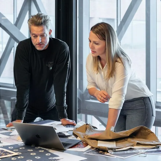 Man and woman looking at a laptop screen