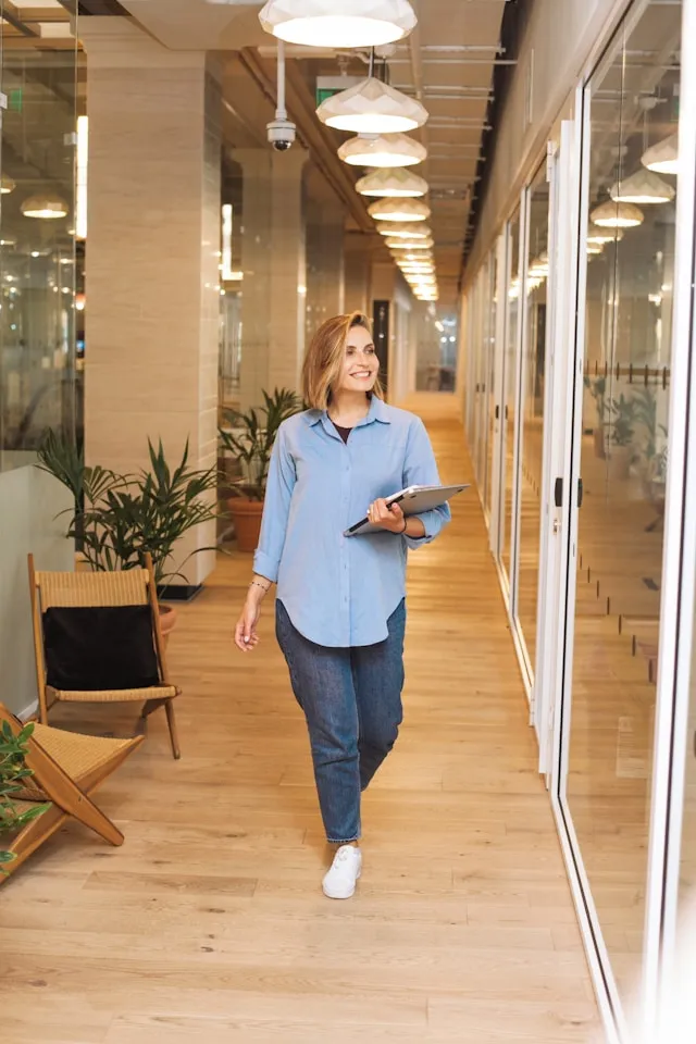 Woman walking through a modern office corridor