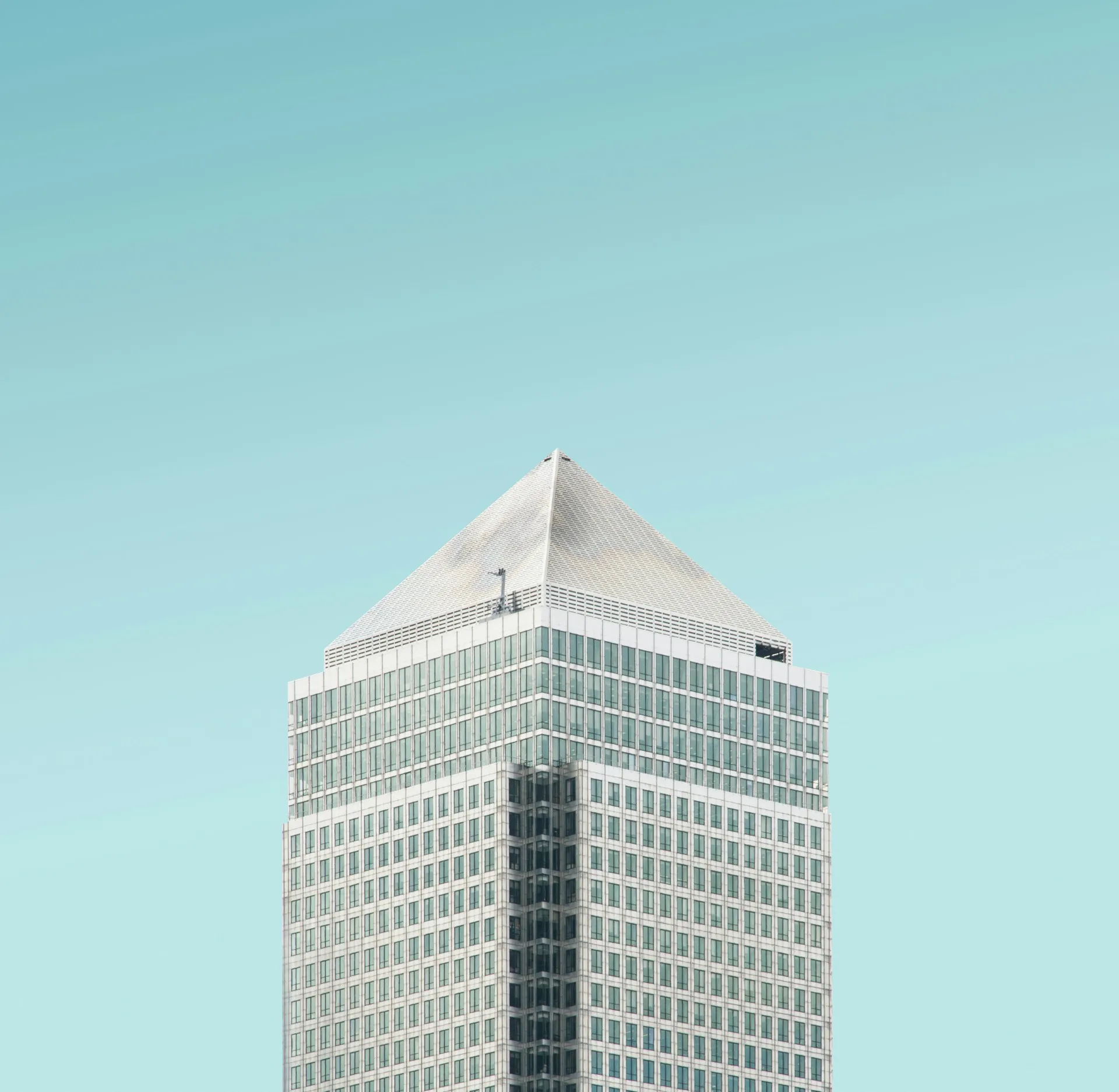 Top of a commercial building with blue sky in the background