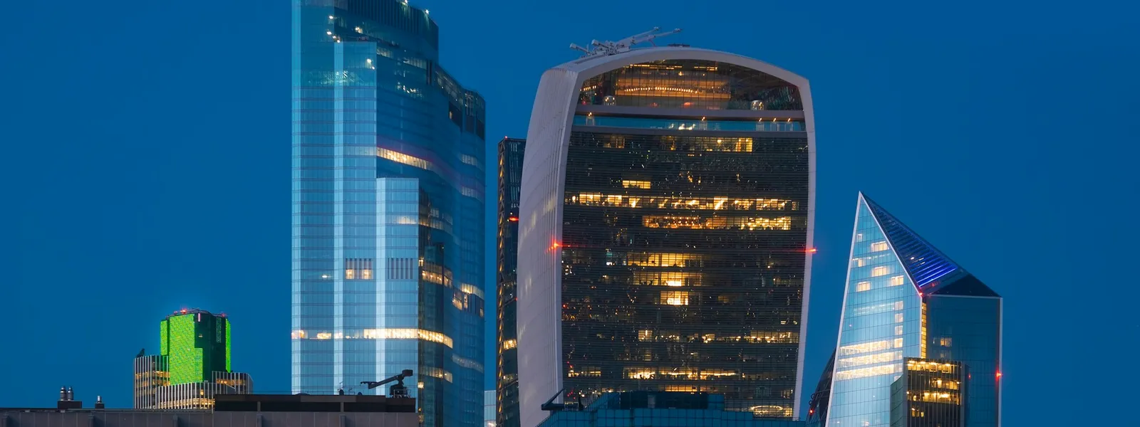 Modern financial district buildings with glass and metal at sunset