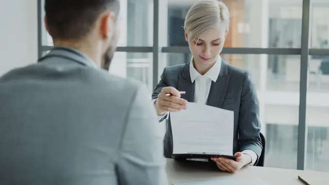 Work meeting reviewing a contract in an office